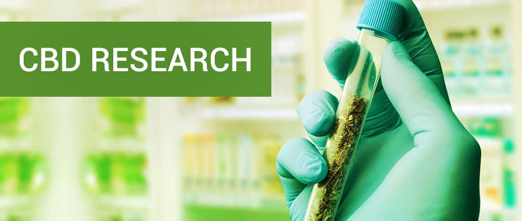 cbd-research-text-with-hand-holding-tube-with-canabis