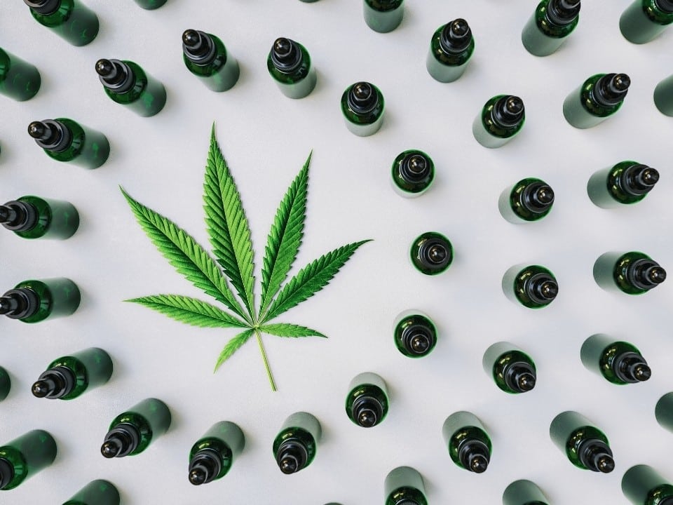 lots of cbd oil with marijuana leaf on the middle