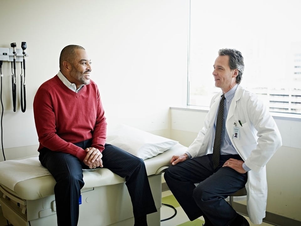 man happily visiting his doctor after trying cbd oil