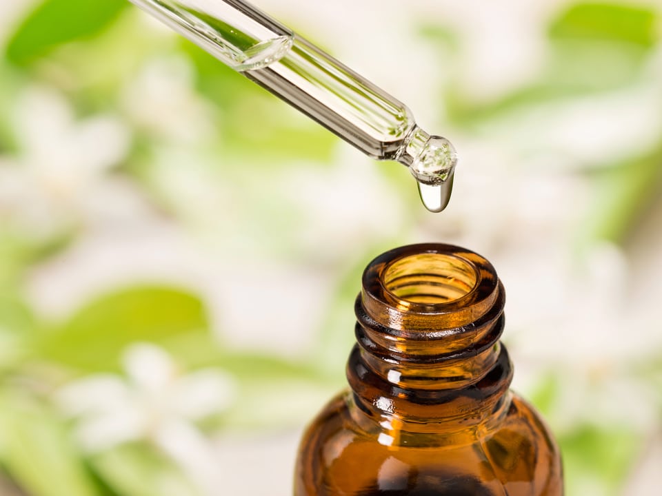 taking out a dropper from a cbd tincture bottle