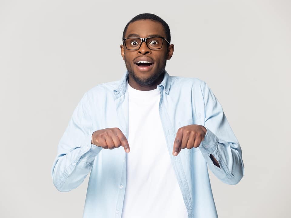 startled man pointing downward