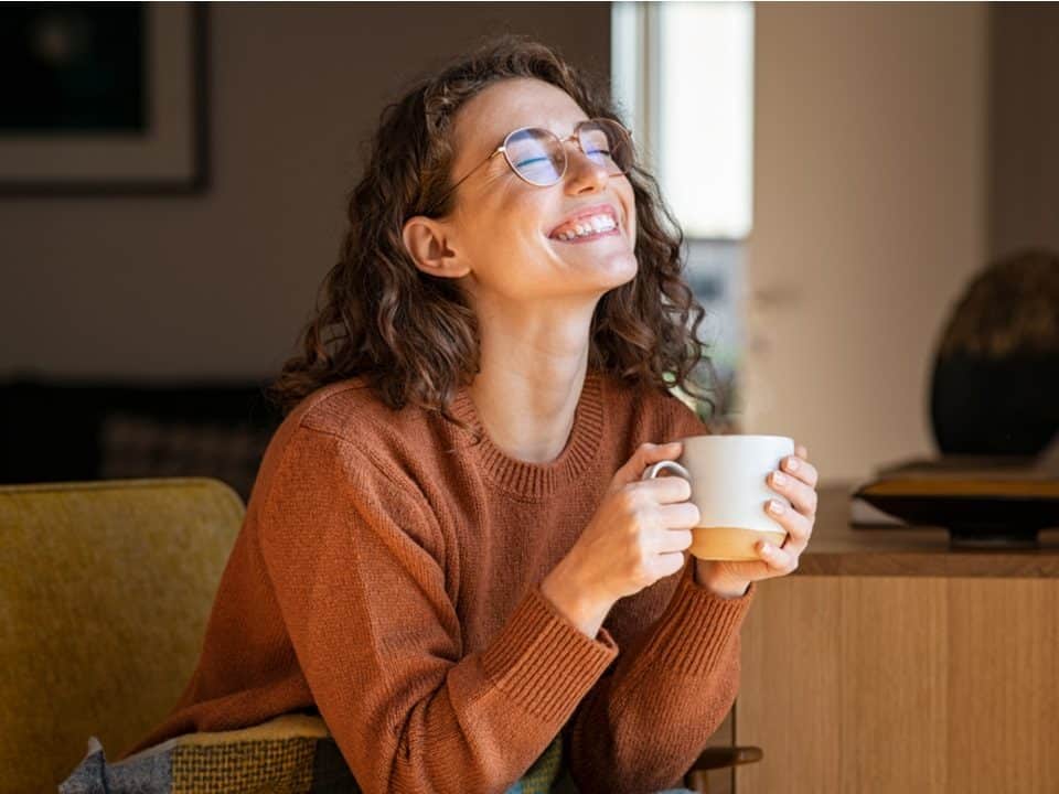 woman delighted while drinking a cbd oil coffee