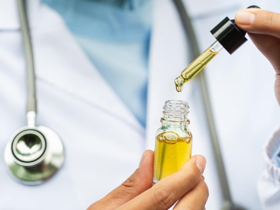 doctor holding cbd oil