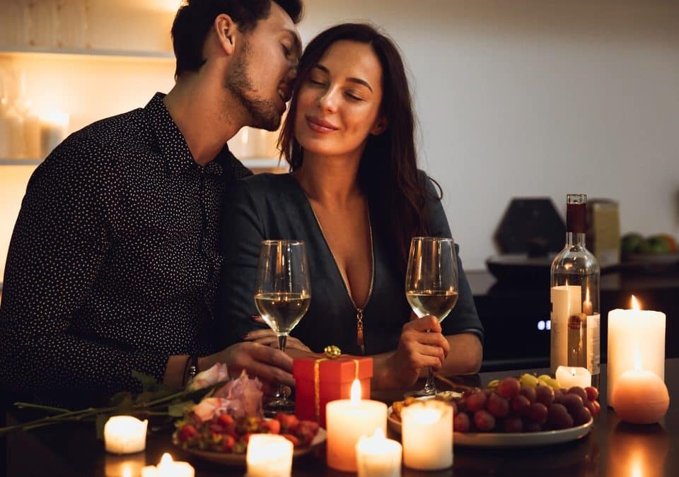 man whispering to his girl on a date