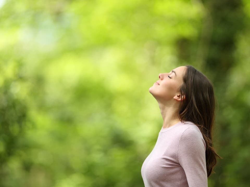 woman feeling relief in a forest
