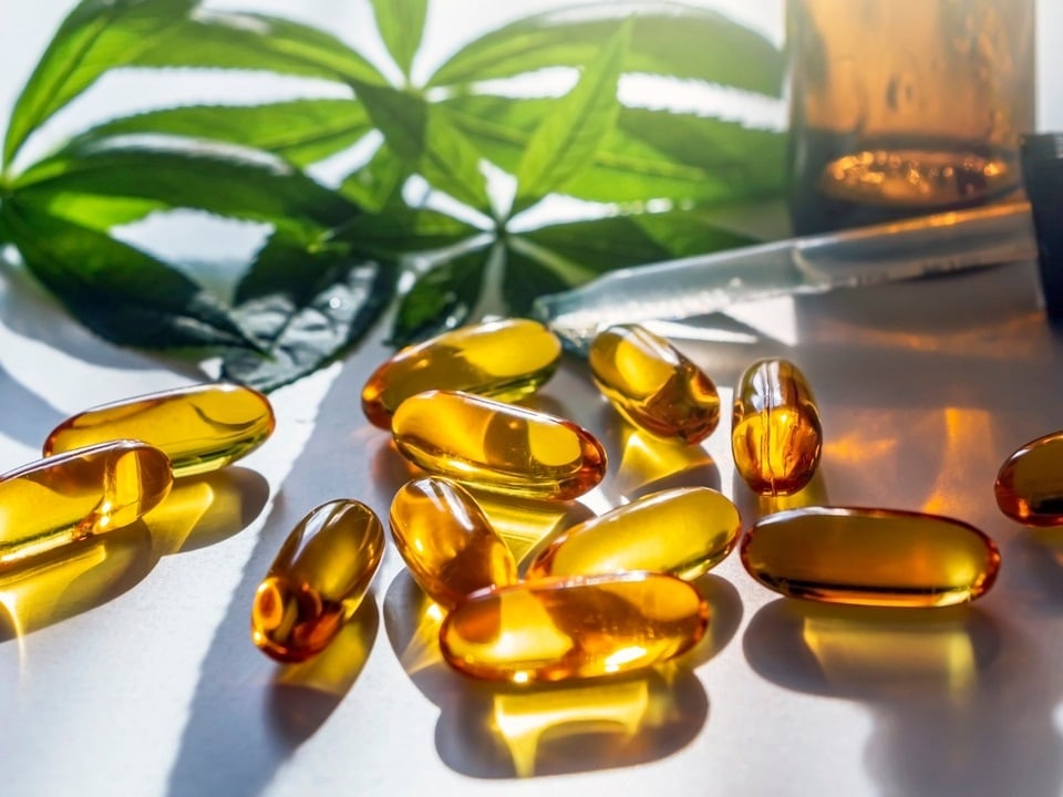 cbd capules and tinctures in a white background