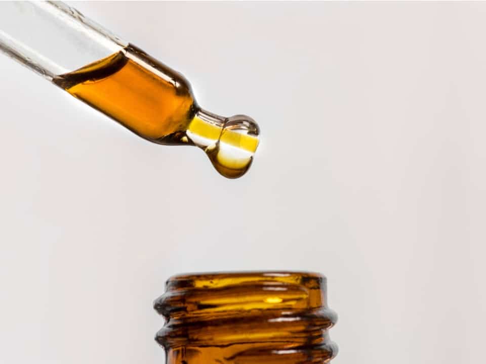 dropper pulling out cbd from a bottle