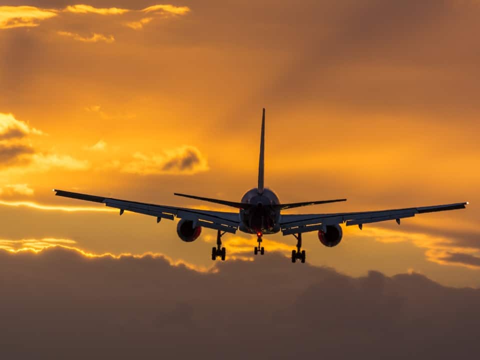 plane flying towards the runway