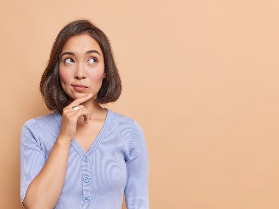 woman thinking of using cbd oil for her acne