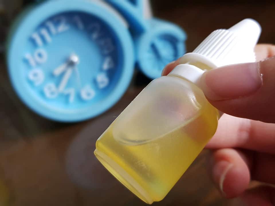 cbd oil with a clock at the background