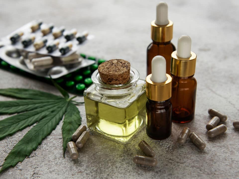 bottles of cbd oil with different types of vitamins