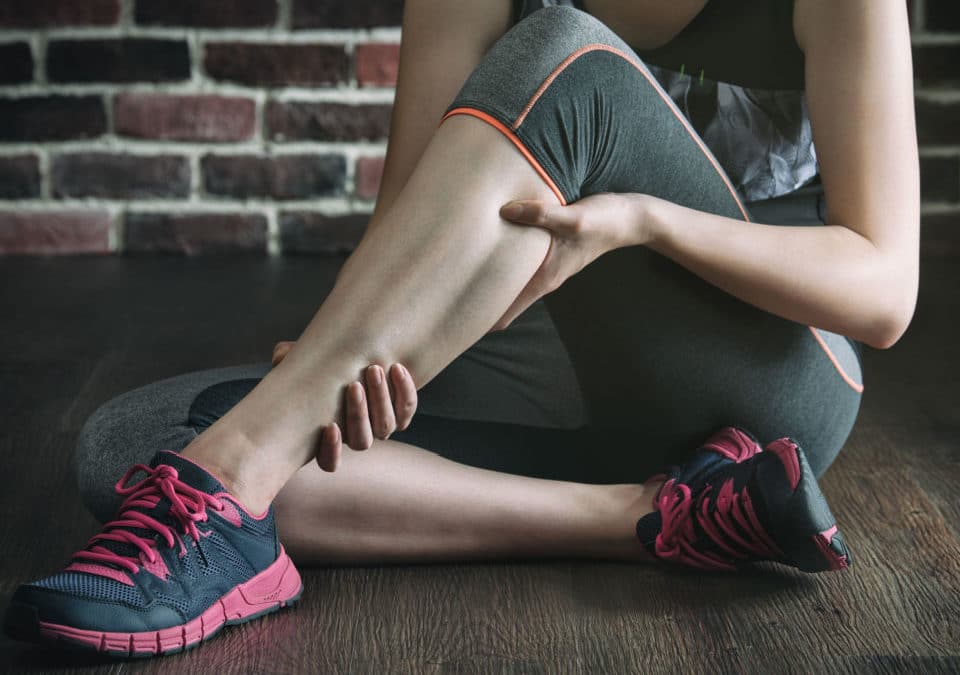 woman have leg cramp during her fitness exercise