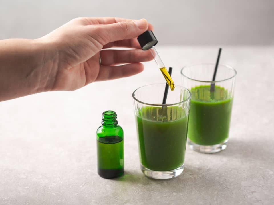 cbd oil dropper bottle and healthy drink