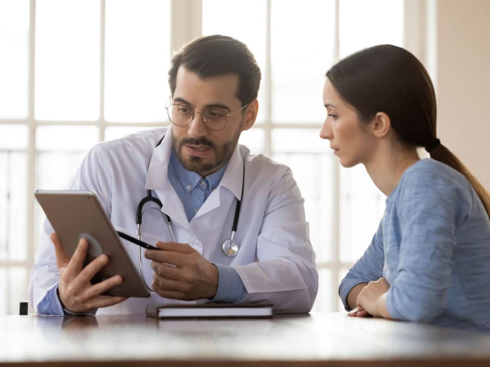 doctor explaining his patient how to microdose cbd