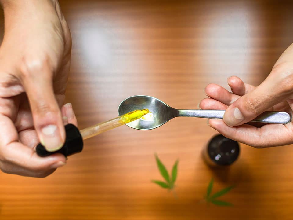 hands measuring cbd dosage for tattooing process